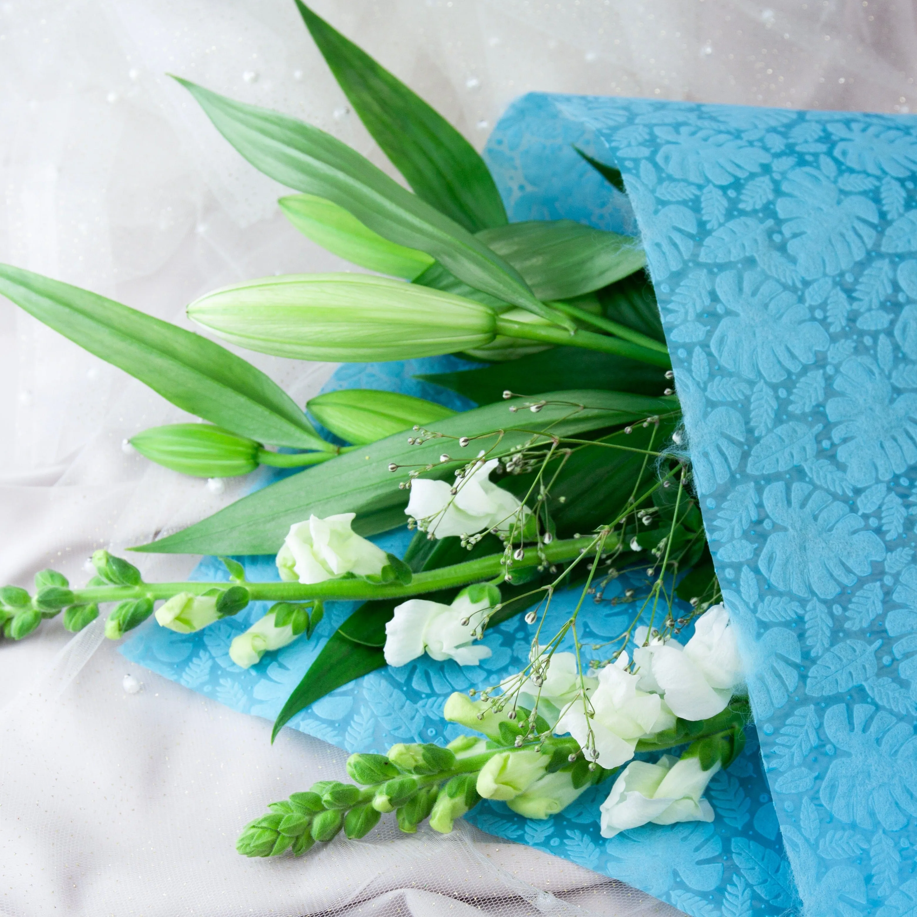 Embossed Non-woven Flower Wrap Tropical Leaves Sky Blue 80gsm Pack 50 (50x70cm)